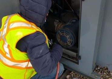 Technician cleaning Makeup Air Unit