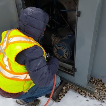 Technician cleaning Makeup Air Unit